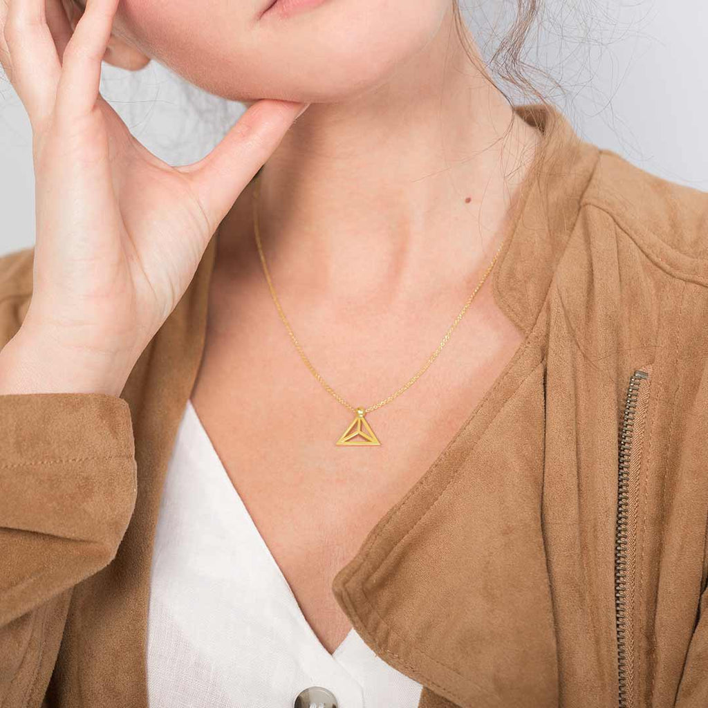 Yoga inspired gold necklace. The jewel represents the lotus flower position. Essential and geometric style. Sliding pendant.